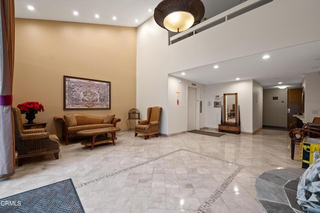 common area featuring recessed lighting and a towering ceiling