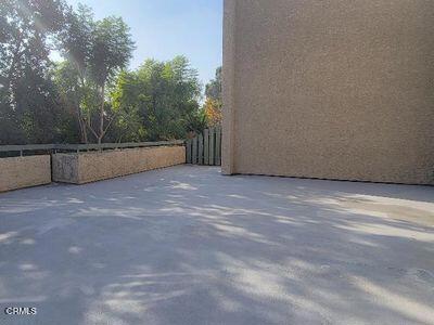 view of side of home featuring fence