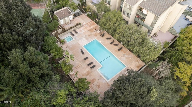 aerial view of property and surrounding area featuring a pool