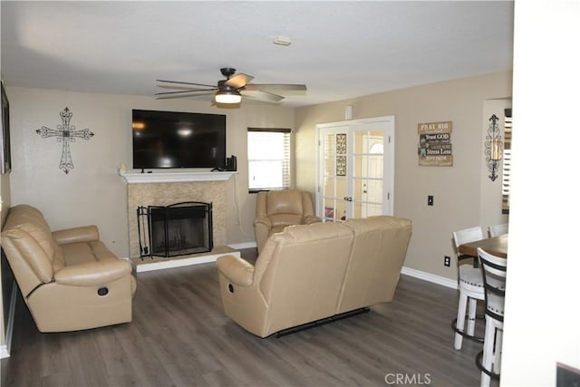 16971 Lakepointe Dr, Riverside, CA 92503 - living room with ceiling fan, dark wood-type flooring, a high end fireplace, and baseboards