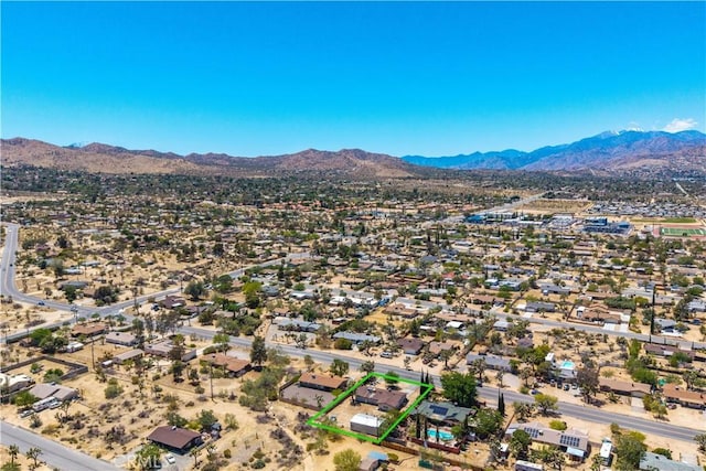 7599 Joshua Ln, Yucca Valley, CA 92284 - aerial overview of property's location with a mountainous background and property boundaries highlighted
