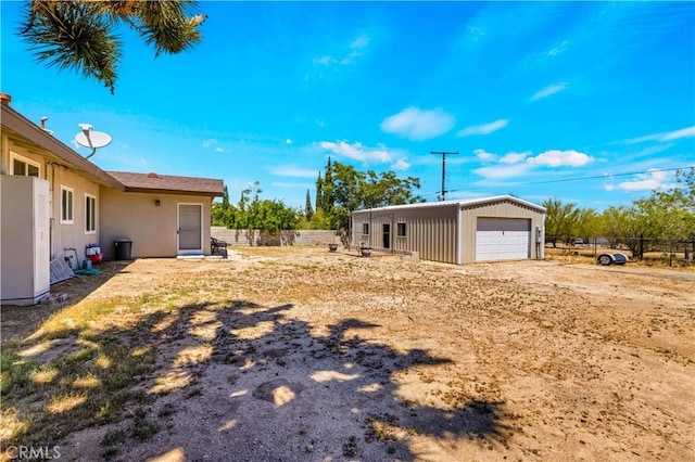 7599 Joshua Ln, Yucca Valley, CA 92284 - view of yard with a garage, fence, and an outbuilding