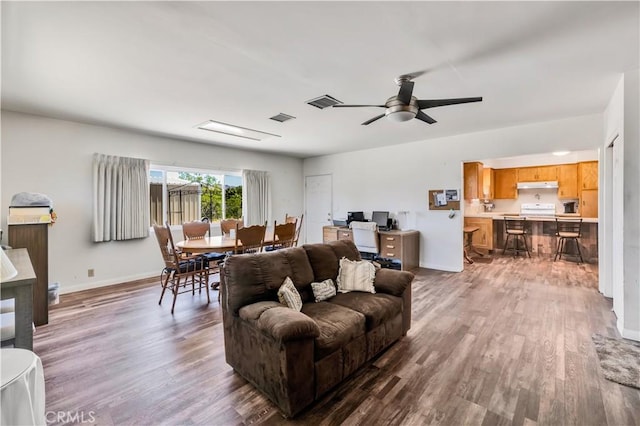 7599 Joshua Ln, Yucca Valley, CA 92284 - living room with wood finished floors, a ceiling fan, and baseboards