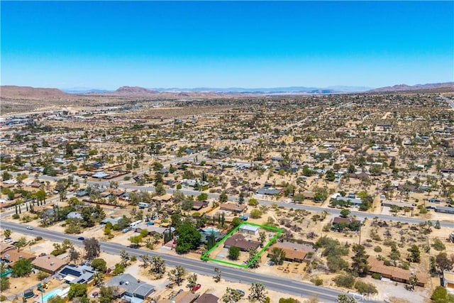 7599 Joshua Ln, Yucca Valley, CA 92284 - aerial view of property and surrounding area with mountains and property parcel outlined