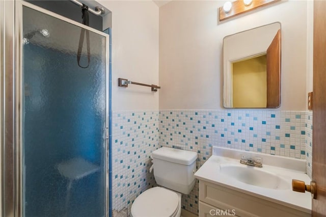 3784 Newton St, Torrance, CA 90505 - bathroom featuring a shower stall, a wainscoted wall, vanity, toilet, and tile walls