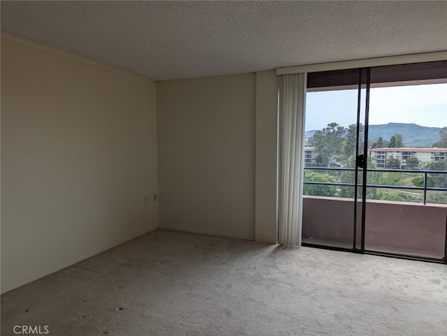 24055 Paseo Del Lago Unit 963, Laguna Woods, CA 92637 - empty room with carpet floors, a textured ceiling, and a mountain view