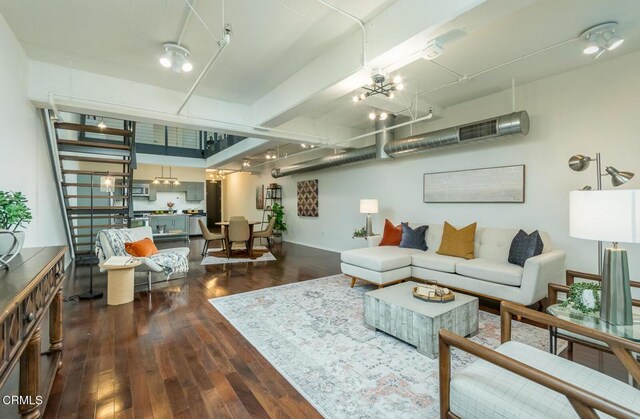 510 S Hewitt St Unit 106, Los Angeles, CA 90013 - living room featuring dark wood finished floors and a chandelier