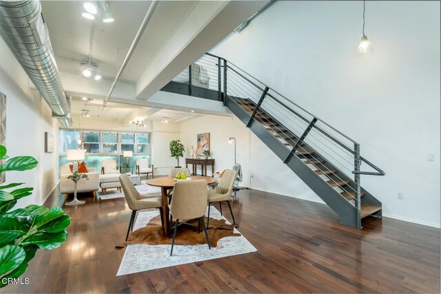 510 S Hewitt St Unit 106, Los Angeles, CA 90013 - dining area featuring wood finished floors, stairway, and a chandelier