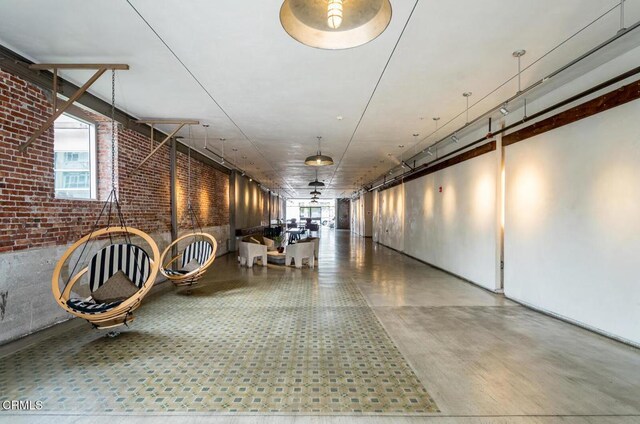 510 S Hewitt St Unit 106, Los Angeles, CA 90013 - hallway featuring tile patterned floors and brick wall