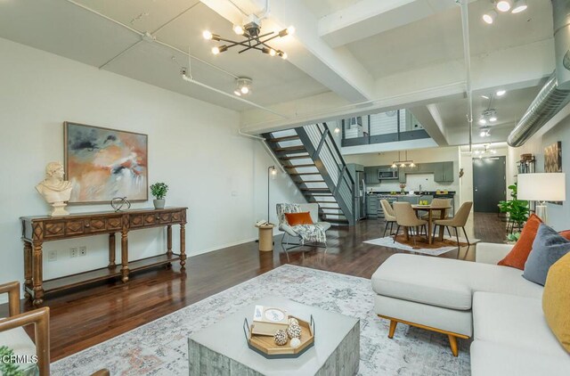 510 S Hewitt St Unit 106, Los Angeles, CA 90013 - living area with wood finished floors, stairway, a chandelier, and beamed ceiling