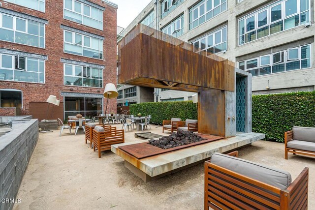 510 S Hewitt St Unit 106, Los Angeles, CA 90013 - view of patio featuring an outdoor living space with a fire pit and outdoor dining area