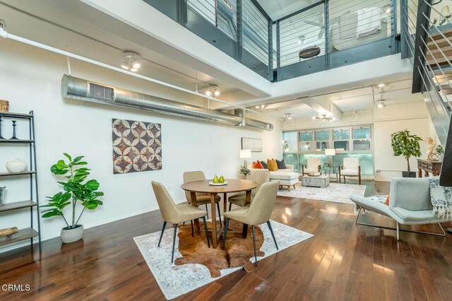 510 S Hewitt St Unit 106, Los Angeles, CA 90013 - dining room featuring wood-type flooring and a towering ceiling