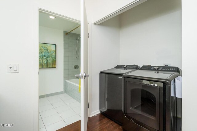 510 S Hewitt St Unit 106, Los Angeles, CA 90013 - washroom featuring washing machine and dryer and dark wood-style flooring