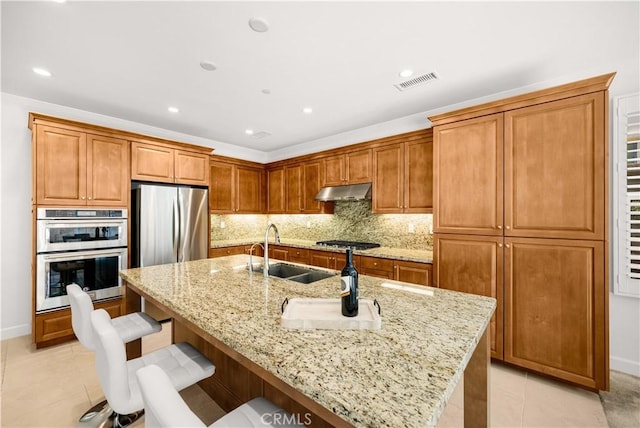 114 Yuba, Irvine, CA 92620 - kitchen with a sink, appliances with stainless steel finishes, light tile patterned floors, a breakfast bar, and a kitchen island with sink