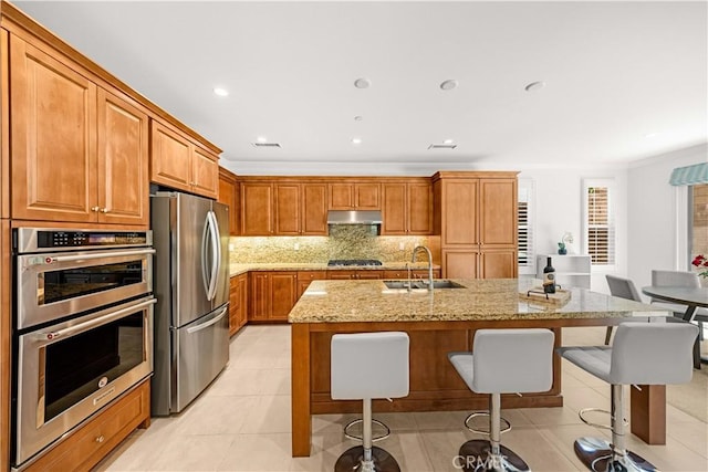 114 Yuba, Irvine, CA 92620 - kitchen with stainless steel appliances, a sink, ornamental molding, light stone counters, and a breakfast bar area
