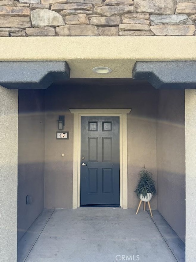 16722 Nicklaus Dr Unit 47, Rancho Cascades, CA 91342 - view of exterior entry with stone siding and stucco siding