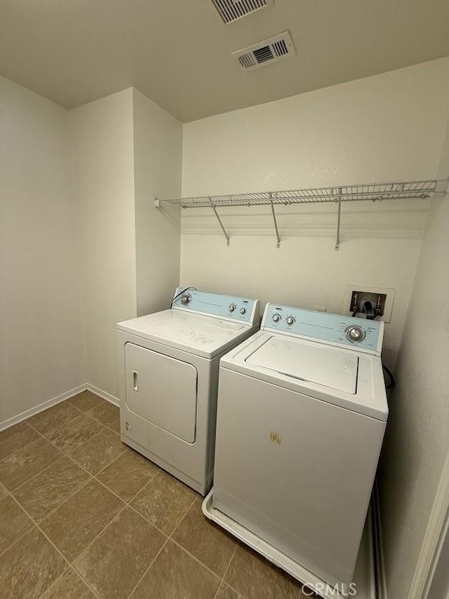 16722 Nicklaus Dr Unit 47, Rancho Cascades, CA 91342 - washroom featuring independent washer and dryer, baseboards, and dark tile patterned floors