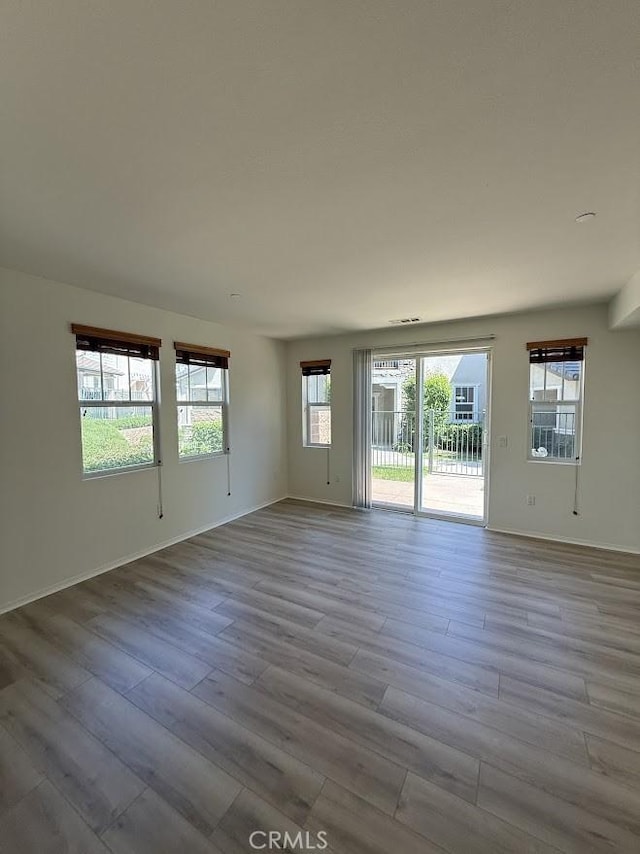 16722 Nicklaus Dr Unit 47, Rancho Cascades, CA 91342 - spare room with healthy amount of natural light, wood finished floors, and baseboards