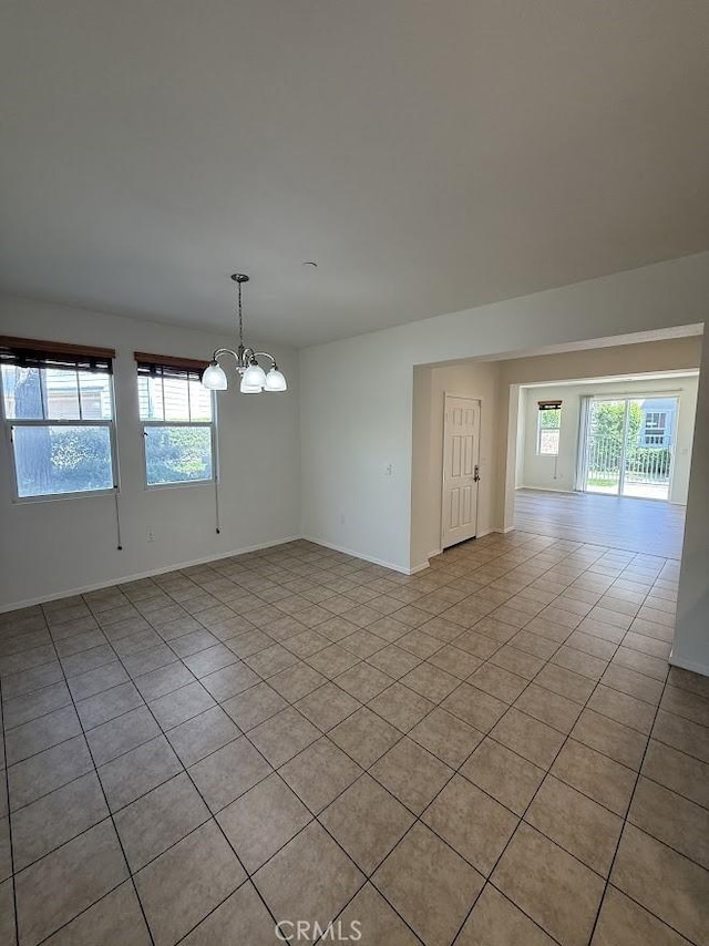 16722 Nicklaus Dr Unit 47, Rancho Cascades, CA 91342 - unfurnished room with light tile patterned flooring, a chandelier, and baseboards