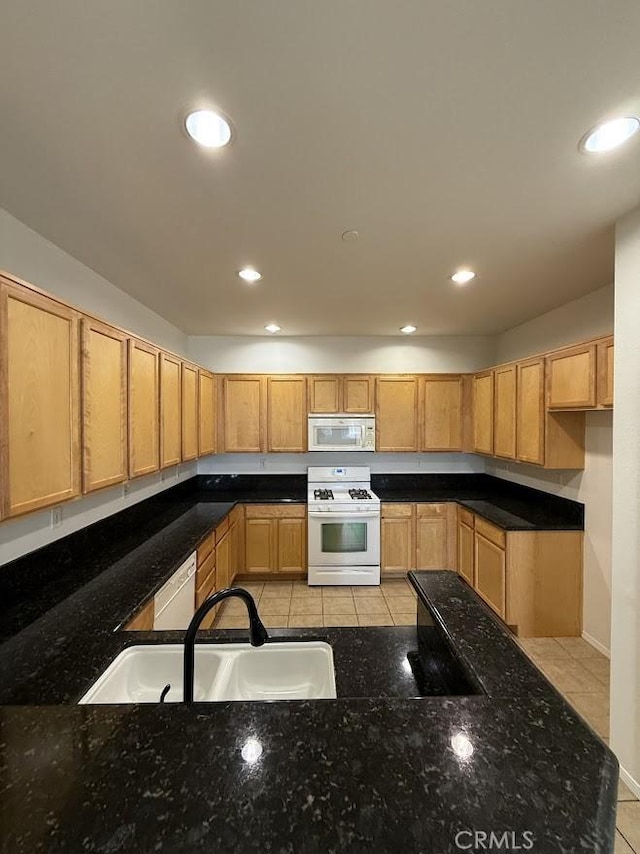 16722 Nicklaus Dr Unit 47, Rancho Cascades, CA 91342 - kitchen featuring white appliances, a sink, light tile patterned flooring, recessed lighting, and dark stone counters