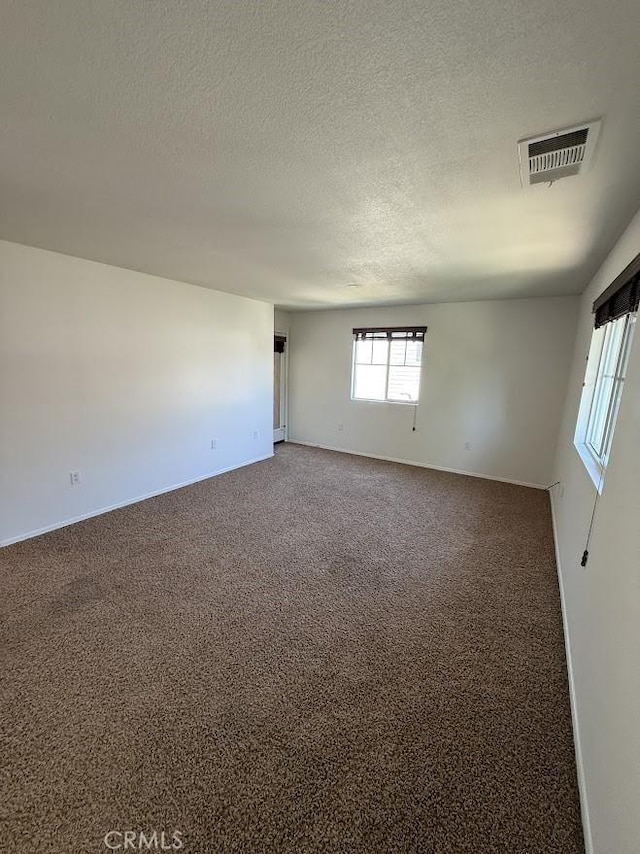 16722 Nicklaus Dr Unit 47, Rancho Cascades, CA 91342 - spare room with carpet flooring, baseboards, and a textured ceiling