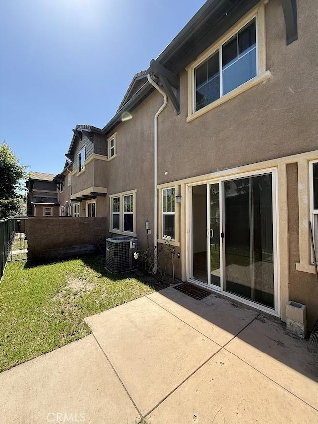 16722 Nicklaus Dr Unit 47, Rancho Cascades, CA 91342 - back of property featuring central air condition unit, a patio, and stucco siding