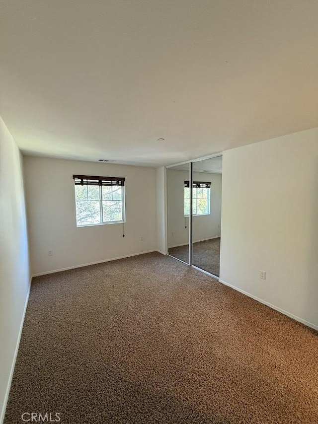 16722 Nicklaus Dr Unit 47, Rancho Cascades, CA 91342 - unfurnished bedroom with carpet flooring, multiple windows, baseboards, and a closet