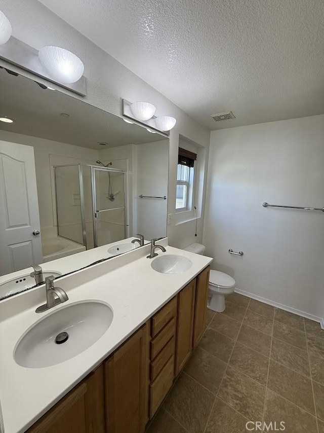 16722 Nicklaus Dr Unit 47, Rancho Cascades, CA 91342 - bathroom with a stall shower, a textured ceiling, toilet, double vanity, and baseboards