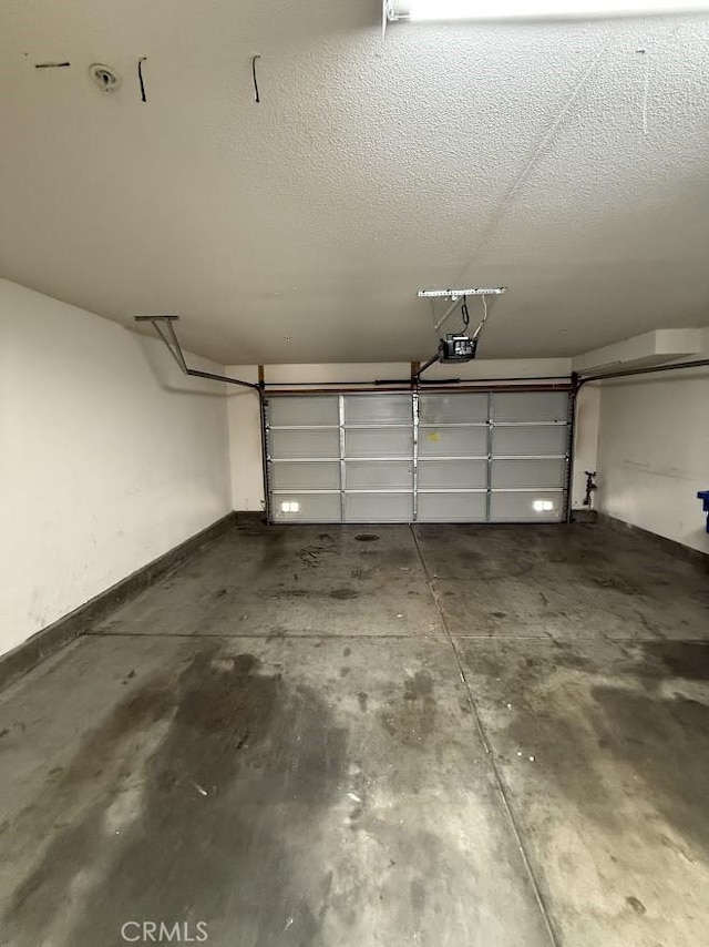 16722 Nicklaus Dr Unit 47, Rancho Cascades, CA 91342 - garage featuring a garage door opener and baseboards