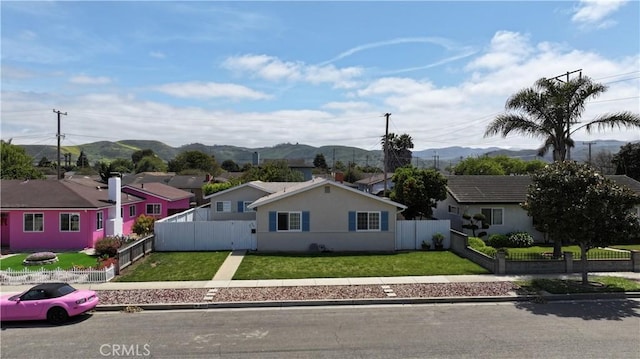 ranch-style home with stucco siding, a mountain view, and a residential view