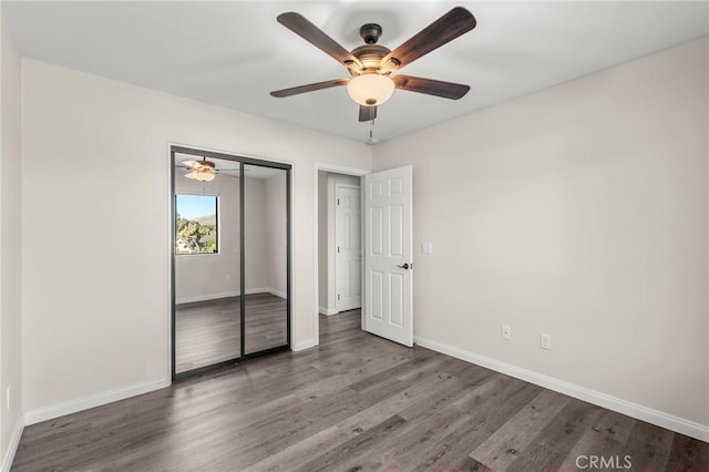 8244 Balsa Ave, Yucca Valley, CA 92284 - unfurnished bedroom with wood finished floors, baseboards, a closet, and a ceiling fan
