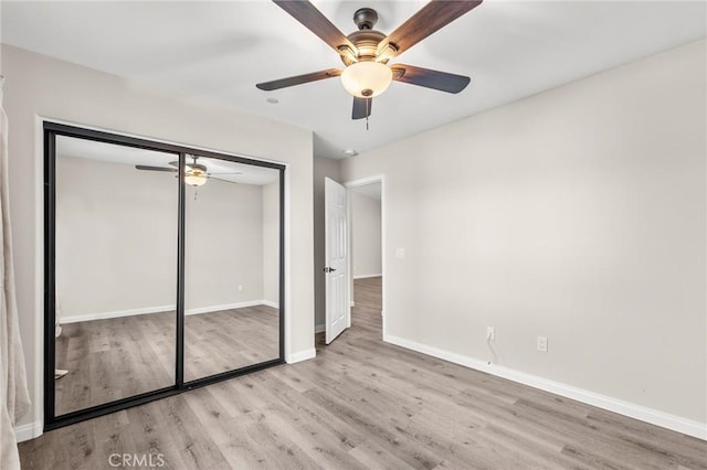 8244 Balsa Ave, Yucca Valley, CA 92284 - unfurnished bedroom featuring wood finished floors, a closet, and ceiling fan