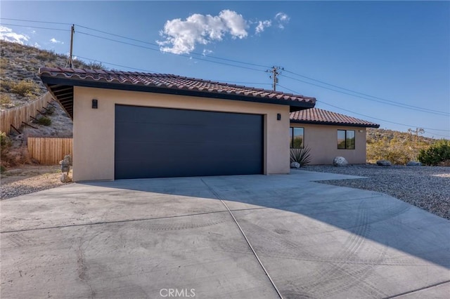 8244 Balsa Ave, Yucca Valley, CA 92284 - mediterranean / spanish-style house with a tiled roof, stucco siding, concrete driveway, and an attached garage