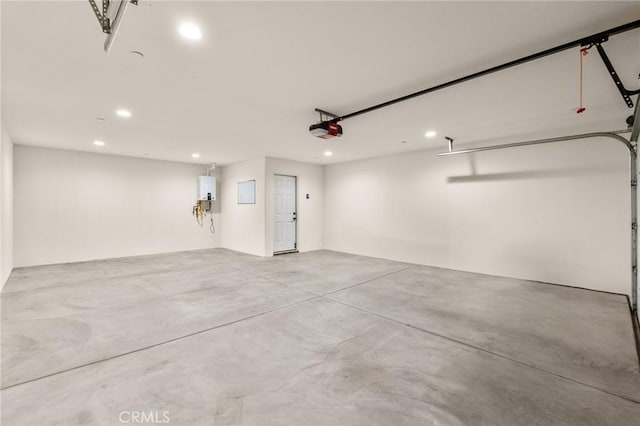 8244 Balsa Ave, Yucca Valley, CA 92284 - garage featuring a garage door opener, recessed lighting, and tankless water heater