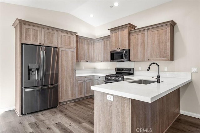 8244 Balsa Ave, Yucca Valley, CA 92284 - kitchen with appliances with stainless steel finishes, a peninsula, light wood finished floors, light countertops, and lofted ceiling