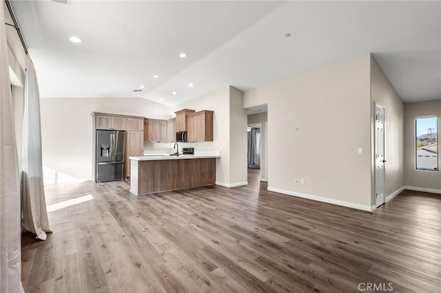 8244 Balsa Ave, Yucca Valley, CA 92284 - kitchen featuring appliances with stainless steel finishes, open floor plan, lofted ceiling, wood finished floors, and light countertops