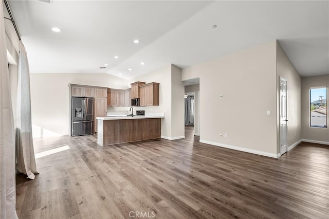 8244 Balsa Ave, Yucca Valley, CA 92284 - kitchen featuring stainless steel appliances, open floor plan, lofted ceiling, wood finished floors, and light countertops