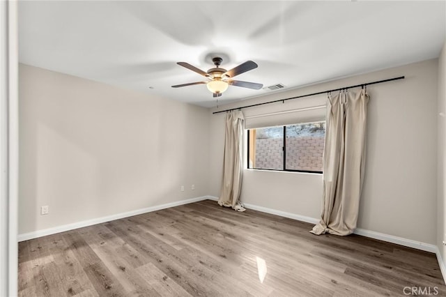 8244 Balsa Ave, Yucca Valley, CA 92284 - unfurnished room with a ceiling fan, wood finished floors, and baseboards