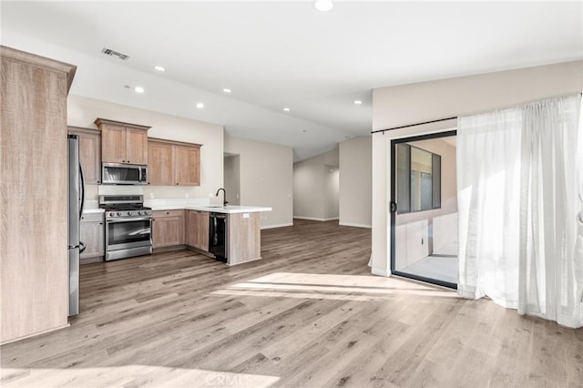 8244 Balsa Ave, Yucca Valley, CA 92284 - kitchen featuring stainless steel appliances, open floor plan, recessed lighting, light wood-style floors, and vaulted ceiling