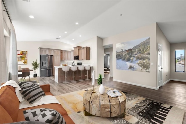 8244 Balsa Ave, Yucca Valley, CA 92284 - living room featuring vaulted ceiling, light wood-style flooring, and recessed lighting