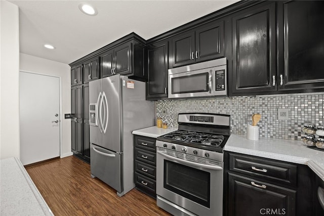 356 Freedom, Upland, CA 91786 - kitchen featuring stainless steel appliances, dark cabinetry, light countertops, dark wood-style floors, and backsplash