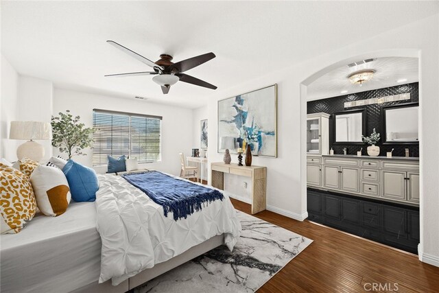 356 Freedom, Upland, CA 91786 - bedroom featuring dark wood-type flooring, connected bathroom, baseboards, arched walkways, and a ceiling fan