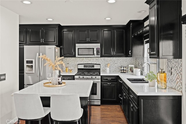 356 Freedom, Upland, CA 91786 - kitchen with stainless steel appliances, dark cabinets, a sink, light countertops, and recessed lighting