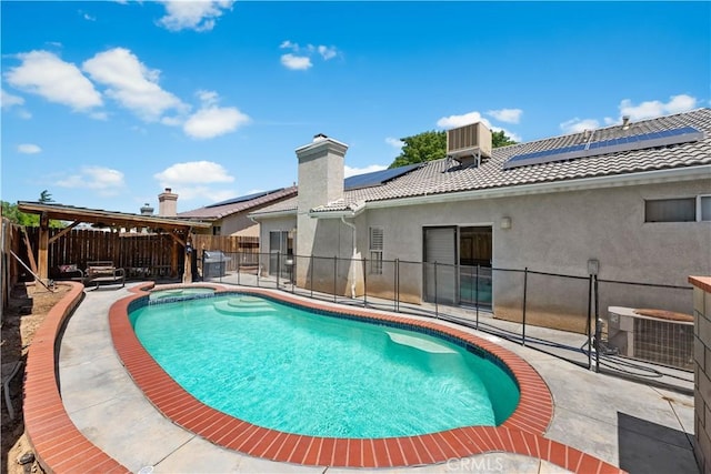 45723 17th St W, Lancaster, CA 93534 - view of swimming pool featuring central air condition unit, a fenced backyard, a pool with connected hot tub, and a patio