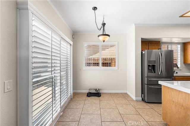 45723 17th St W, Lancaster, CA 93534 - kitchen with stainless steel fridge, plenty of natural light, tile counters, and crown molding