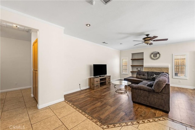45723 17th St W, Lancaster, CA 93534 - living room featuring a ceiling fan, light tile patterned floors, crown molding, and baseboards