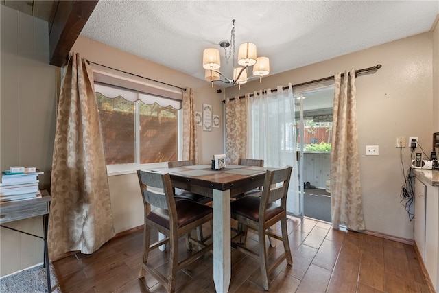 5203 Desert View Dr, Wrightwood, CA 92397 - dining room with wood finished floors, a chandelier, a textured ceiling, and baseboards