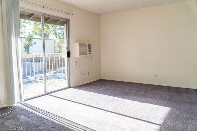 8990 19th St Unit 268, Rancho Cucamonga, CA 91701 - empty room featuring carpet flooring, a textured ceiling, a wall mounted AC, and baseboards