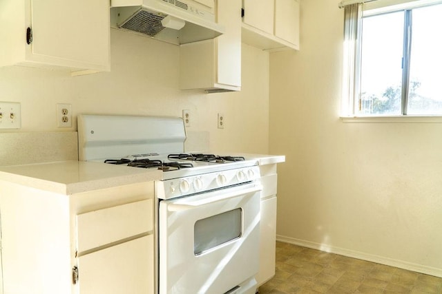 8990 19th St Unit 268, Rancho Cucamonga, CA 91701 - kitchen featuring gas range gas stove, under cabinet range hood, baseboards, light countertops, and healthy amount of natural light
