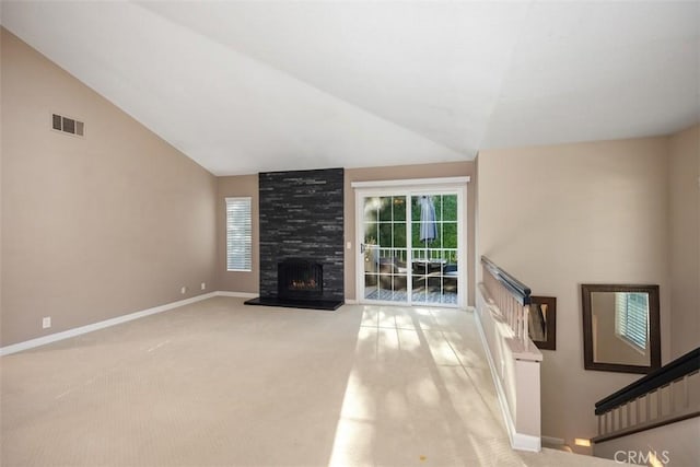 81 Cloudcrest, Aliso Viejo, CA 92656 - unfurnished living room with light colored carpet, vaulted ceiling, healthy amount of natural light, and a fireplace